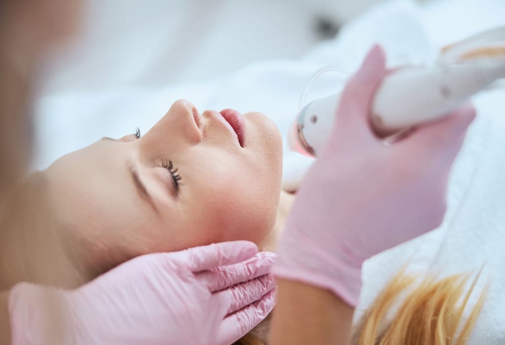 Blonde woman receiving the fractional microneedling treatment